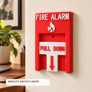 May include: A rectangular red fire alarm switch cover featuring white raised text that reads FIRE ALARM at the top and PULL DOWN on a white T-shaped handle. A white flame icon is positioned between the text and the handle, with a downward arrow.