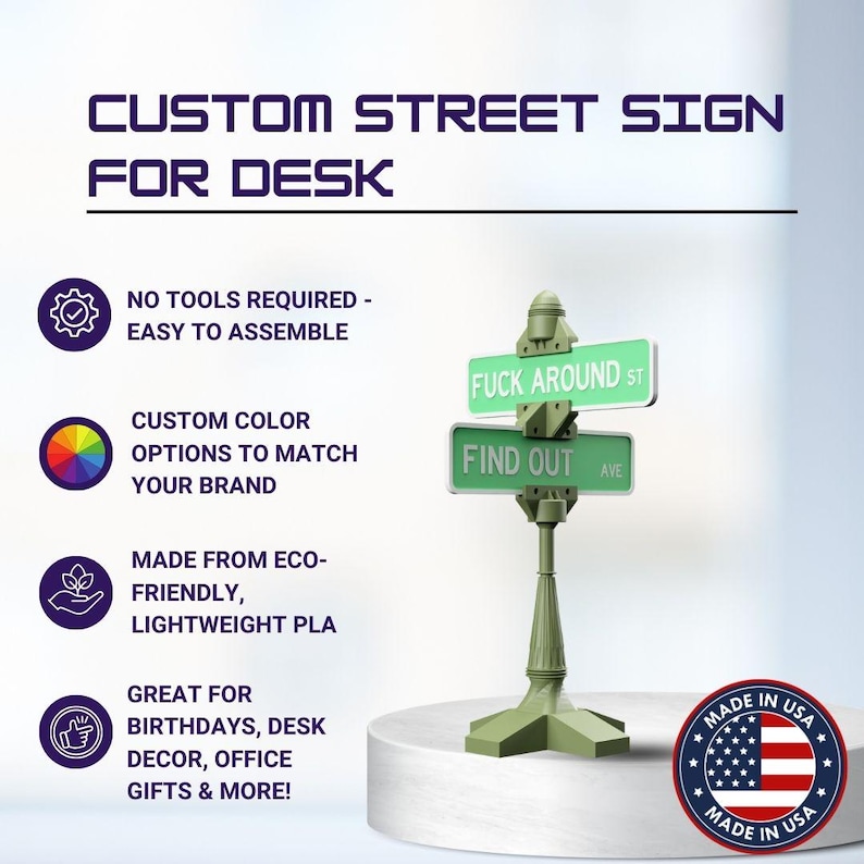 May include: A green desk street sign with the text "FUCK AROUND ST" and "FIND OUT AVE". The sign is on a white pedestal. The sign is made in the USA.