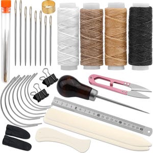 May include: A leathercrafting kit with various tools and supplies. The kit includes needles, thread spools in white, brown, tan, and black, a thimble, curved needles, binder clips, an awl, pink scissors, a ruler, and bone folders.