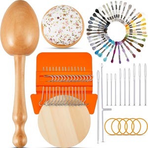 May include: A collection of sewing and embroidery supplies. Includes a wooden egg-shaped darning mushroom, a floral pin cushion, a variety of needles, embroidery floss in a rainbow of colors, and an orange needle case with hooks and needles.