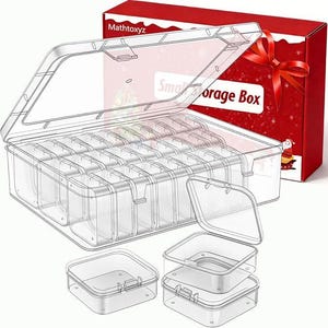 May include: Clear plastic storage box with multiple compartments and individual small containers. The box has a hinged lid and is partially open. A red gift box with a bow is in the background. The text "Small Storage Box" is visible.