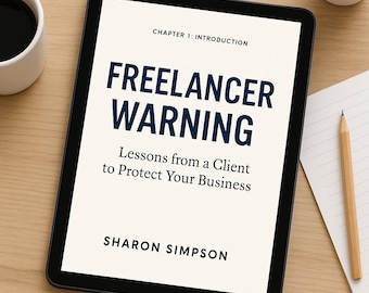 May include: A black tablet displays the title "FREELANCER WARNING" in navy blue, with the subtitle "Lessons from a Client to Protect Your Business." The author's name, Sharon Simpson, is below. A cup of coffee, a pencil, and a small plant are also visible.