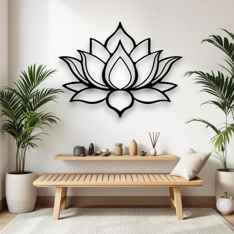 May include: Black metal lotus flower wall art. The floral design is mounted on a white wall above a wooden bench. The room is decorated with potted plants and decorative items, creating a serene atmosphere.
