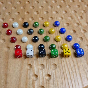 May include: A wooden game board with a variety of colored marbles and dice. The marbles are arranged in a triangular pattern, and the dice are in a row at the bottom of the board. The dice are red, white, black, green, yellow, and blue.