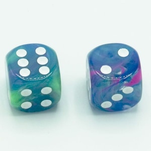 May include: Two blue dice with white dots. The dice have a marbled, swirled appearance with hints of green and pink.
