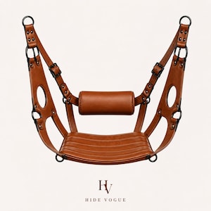 May include: A brown leather swing chair with black metal rings and buckles. The chair has a padded seat and backrest, and a cylindrical headrest. The brand name "HIDE VOGUE" is printed at the bottom.