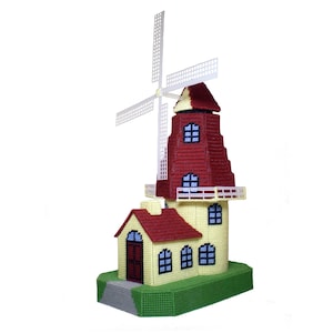 May include: A handcrafted windmill model with a red roof and blades, and a yellow body. The windmill has a small house attached to it, and is sitting on a green base. The windmill blades are white.