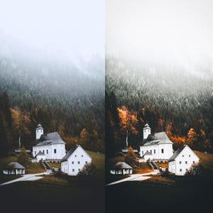 May include: A picturesque scene of a white church and buildings in a valley, set against a backdrop of a misty mountain range. The surrounding trees display autumnal colours, creating a warm contrast.