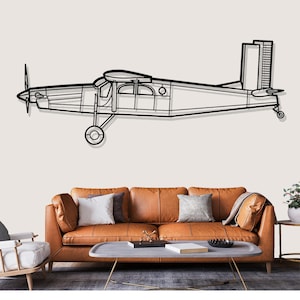 May include: Black metal airplane wall art. The artwork depicts a detailed outline of a vintage airplane, including the propeller, wings, and tail. The piece is designed to be mounted on a wall, adding a touch of aviation-themed decor.
