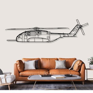 May include: Black metal helicopter wall art. The artwork depicts a detailed outline of a helicopter, including the rotors and body. The piece is mounted on a neutral-colored wall above a brown leather sofa.