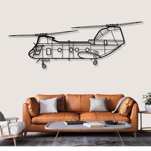 May include: Black metal wall art depicting a Chinook helicopter. The artwork features detailed outlines of the aircraft's body, rotors, and landing gear. The helicopter is mounted above a brown leather sofa with decorative pillows.
