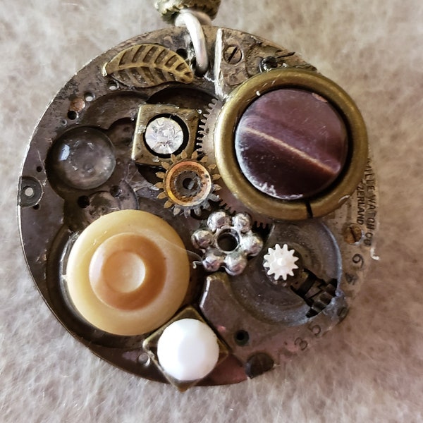 STEAMED UP, An Up Cycled Collage Unisex Necklace, Made from Vintage watch parts using mixed metals, buttons and found objects.