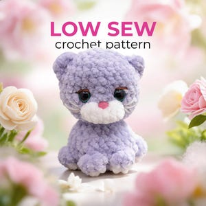 May include: A lavender crochet cat with large, expressive eyes and a pink nose. The cat is sitting, with the text "LOW SEW crochet pattern" above it. The background features soft focus flowers in shades of pink and white.