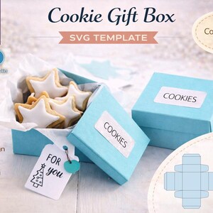 May include: A light blue cookie gift box with star-shaped cookies inside. The box has a label that says "COOKIES". The image also includes a tag that says "FOR you". The design is easy to assemble and great for gift giving.