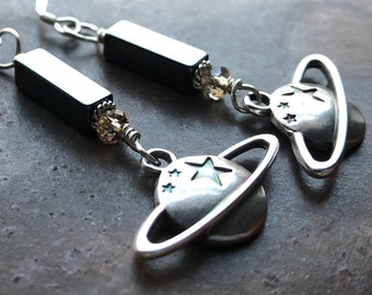 LIMITLESS. hematite earrings with silver-plated Saturn charm. handmade. optional leverbacks or hypoallergenic hooks.