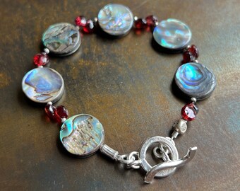 PEGASUS BAY. shell bracelet. garnets. Hill Tribe silver toggle bracelet. one of a kind. ocean beach bum exotic jewelry. Sundance style.