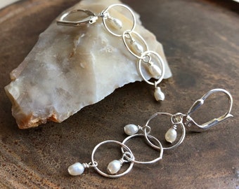 SIGNATURE SHORTIES. white freshwater pearl earrings. sterling silver. circle hoops. beach bum. optional hypoallergenic hooks. Sundance style
