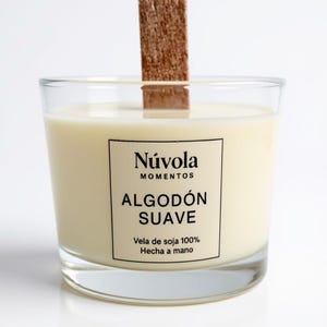 Scented soy candle with a wooden wick. Handcrafted in a glass jar, featuring Soft Cotton, Black Lilium, or Orange & Cinnamon scents.