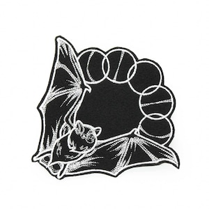 May include: Black and white embroidered iron-on patch featuring a bat with its wings spread out around a circle of moons.