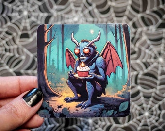 Cryptid Series Mothman Eating Birthday Cupcake Sticker - Vinyl, Machine Die Cut & Water Resistant