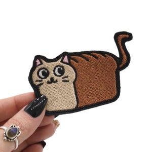 May include: A set of three ceramic mugs with a speckled, matte finish. Each mug features a different color: light blue, cream, and gray. The mugs have a simple, modern design and a comfortable handle.