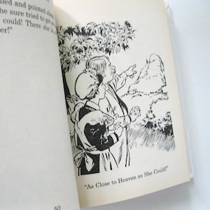 May include: Monochrome illustration from a book. Two figures are pointing towards a mountain. The text "As Close to Heaven as She Could!" is at the bottom of the page.