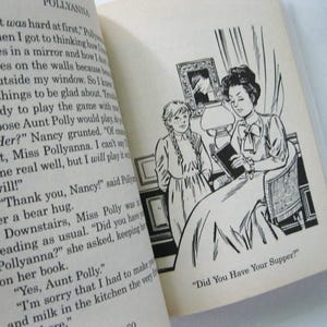 May include: An open book with text and a black and white illustration. The illustration shows two women, one seated and reading a book, and the other standing nearby. The text reads "Did You Have Your Supper?"