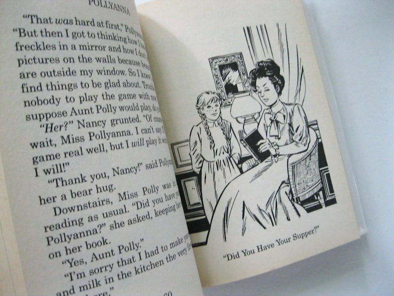 May include: An open book with text and a black and white illustration. The illustration shows two women, one seated and reading a book, and the other standing nearby. The text reads "Did You Have Your Supper?"