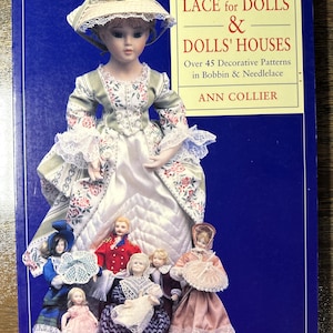 May include: A book titled "LACE for DOLLS & DOLLS' HOUSES" featuring a doll in a period dress and several other dolls. The cover is blue with white text and a gold border. The book is about decorative patterns in bobbin and needlelace.