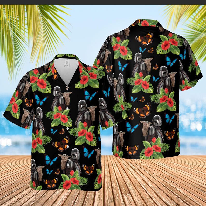 May include: Black Hawaiian shirt featuring a repeating pattern of a Mandalorian character, a small green creature, red hibiscus flowers, and butterflies. The shirt has short sleeves and a button-down front.