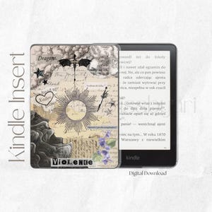May include: Kindle Insert with a collage design featuring a dragon, stars, and sunburst. The design includes text elements like "Dragons," "Xaden," and "Violence." The Kindle is open, displaying text on the screen.
