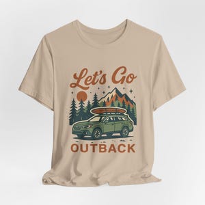 Retro adventure tee with Let’s Go Outback design, Subaru inspired SUV, camping scene, and boho outdoors graphic shirt for car enthusiasts