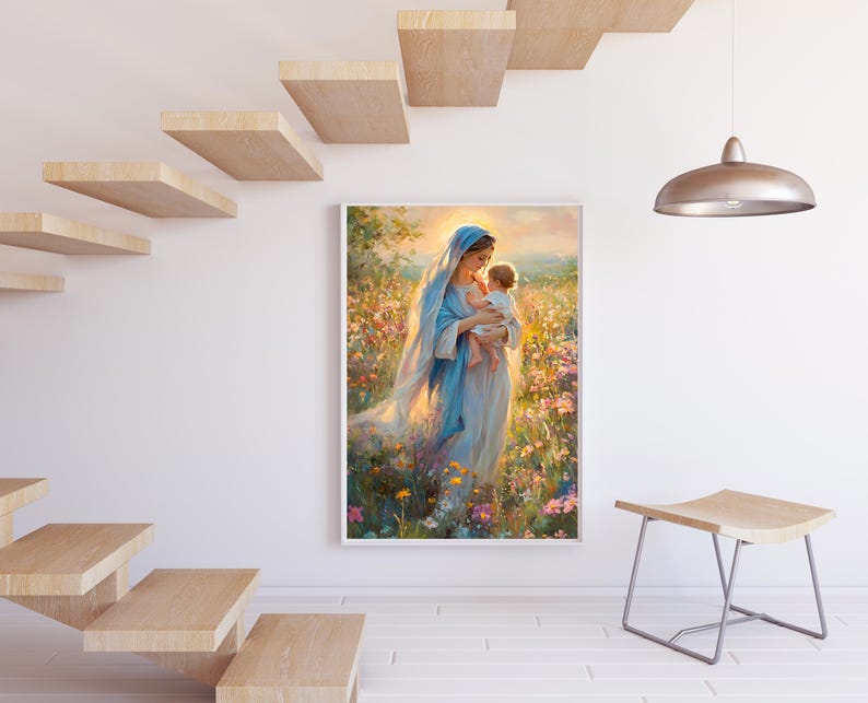 May include: A framed painting depicts a woman in a blue robe holding a baby in a field of flowers. The artwork has a soft, painterly style with warm, golden light. The painting is displayed on a white wall near a wooden staircase and a modern stool.