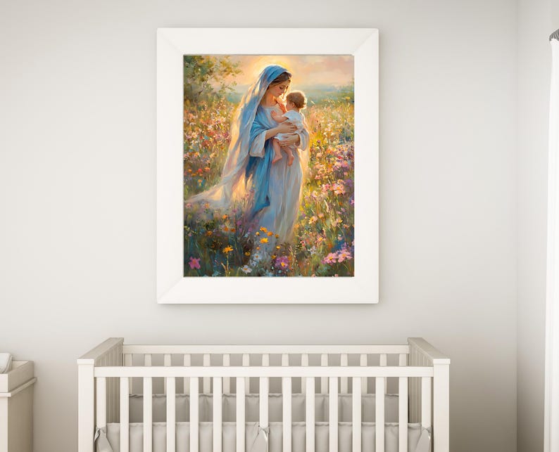 May include: A framed print of a woman in a blue veil holding a baby in a field of flowers. The artwork has a soft, painterly style with warm, natural colors. The white frame complements the artwork, creating a serene and peaceful atmosphere.