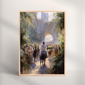 Puede incluir: Una impresión enmarcada representa una escena religiosa con figuras a pie y a caballo entrando por una puerta de la ciudad. La obra de arte presenta una iluminación suave, con una figura central montada en un burro. La paleta de colores incluye verdes, marrones y blancos apagados.