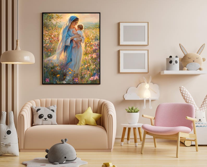 May include: A framed artwork depicts a woman in a blue robe holding a child in a field of flowers. The room features a pink sofa with decorative pillows, a pink chair, and a small side table with a plant. Two framed blank pictures are on the wall.