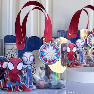 May include: A white ceramic mug with a black handle and the text "But first, coffee" in a handwritten style. The mug is on a white surface. The mug is approximately 4 inches tall.