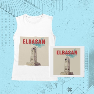 May include: White vest top with a graphic of a stone clock tower and the word "ELBASAN" in red. A smaller print of the same design is also visible. The background is light blue with abstract shapes.