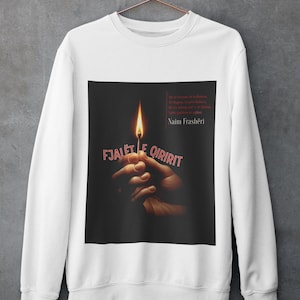 May include: White sweatshirt featuring a graphic of a lit match held by hands against a black background. The text "FJALËT E QIRIRIT" is in red, with additional text and the name "Naim Frashëri" in the upper right corner.