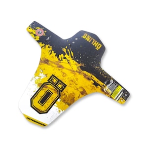 May include: A black, yellow, and white CUSTOMMUDGUARD bicycle fender with the brand name "ÖHLINS" printed on it. The fender has a unique design with yellow paint splatters and the number "0" in a yellow outlined rectangle.