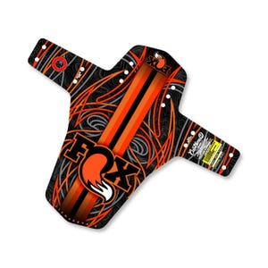 May include: Black and orange mountain bike mudguard with the Fox logo and a custom design. The mudguard has mounting holes and a pattern of orange and grey lines.