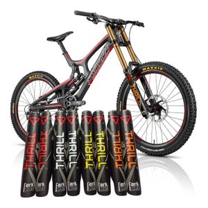 May include: A black and red mountain bike with gold suspension forks and Maxxis tyres. The bike is accompanied by several black fork guards with the word "THRILL" in various colours.