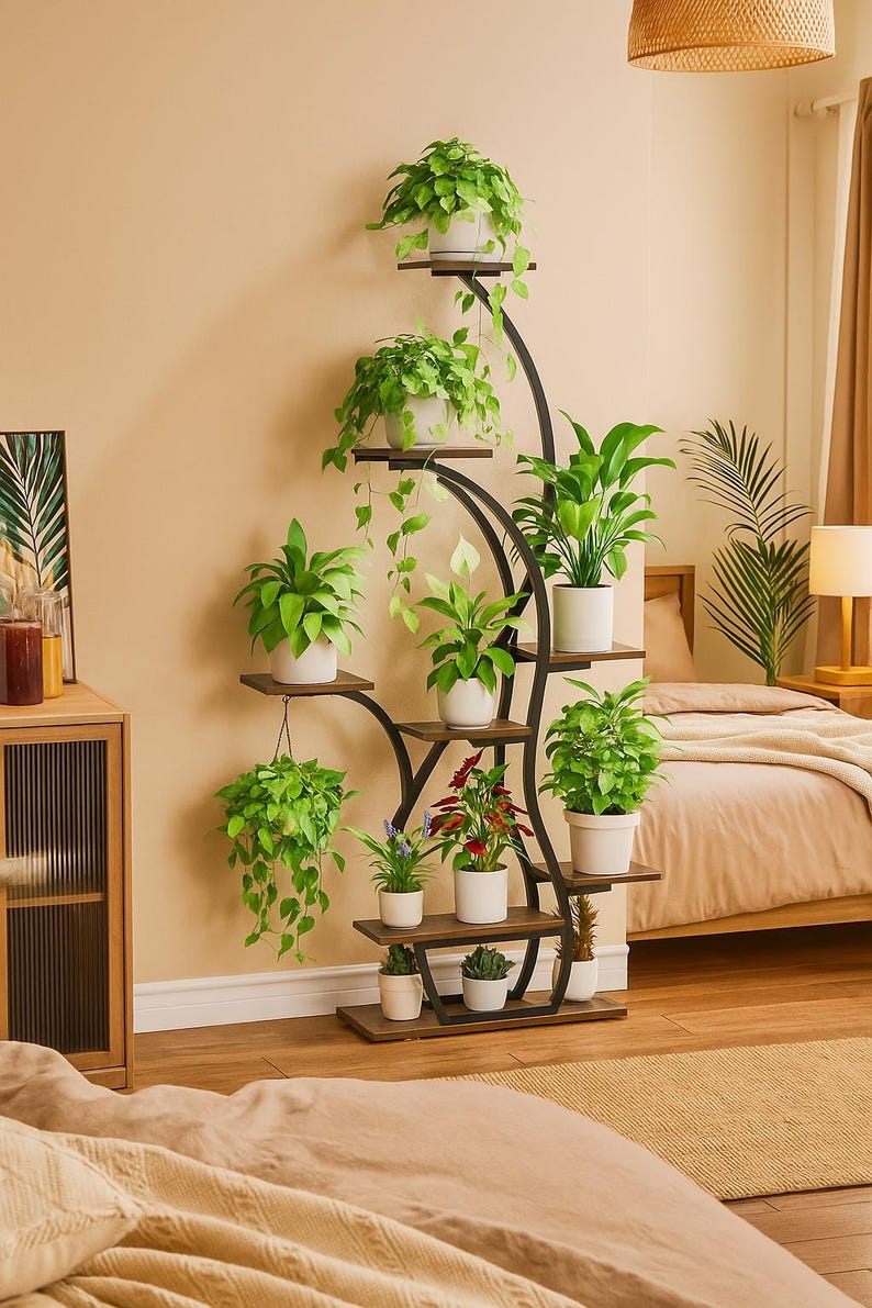 May include: A multi-tiered plant stand with a black metal frame and wooden shelves. The stand holds various potted plants with green foliage and white pots. The design is curved and adds a decorative element to the room.