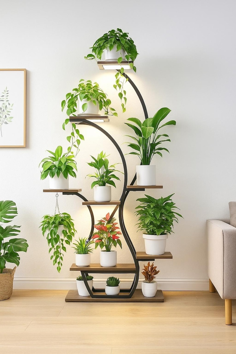May include: A tall, black metal plant stand with multiple wooden shelves and built-in lighting. The stand holds various potted plants with green foliage and white pots, creating a modern indoor garden display. The stand is approximately 6 feet tall.