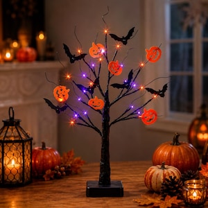 May include: A black decorative tree with thin branches featuring orange jack-o'-lantern cutouts and black bat silhouettes. The tree is illuminated by small, integrated orange and purple LED lights and stands on a square black base.