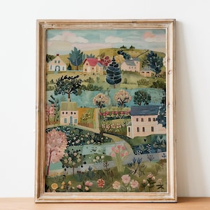 Könnte beinhalten: Ein gerahmtes Aquarellgemälde einer malerischen Dorflandschaft. Das Kunstwerk zeigt farbenfrohe Häuser, üppiges Grün und blühende Blumen. Das Gemälde ist in einem rustikalen, hellen Holzrahmen gefasst, was dem Kunstwerk einen Hauch von Vintage-Charme verleiht.