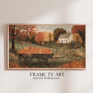 Könnte beinhalten: Ein gerahmter Landschaftsdruck mit einer ländlichen Szene mit einem Bauernhaus und einem Wagen voller Kürbisse. Das Kunstwerk zeigt Herbstfarben mit orangefarbenem und gelbem Laub und einem Holzkarren. Der Text "FRAME TV ART INSTANT DOWNLOAD" steht unten.