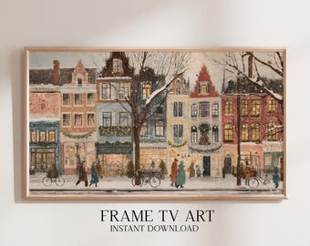 May include: A framed watercolor painting of a European street scene in winter. The artwork depicts colorful buildings, pedestrians, bicycles, and snow-covered trees. The text "FRAME TV ART INSTANT DOWNLOAD" is at the bottom.