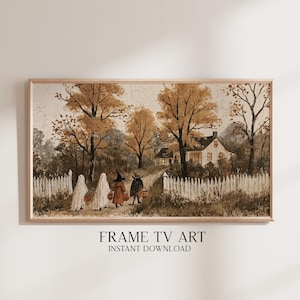 May include: A rectangular framed digital print featuring a vintage-style painting of four children in Halloween costumes walking along a dirt path towards a house. The scene includes a white picket fence, autumn trees, and orange jack-o'-lantern buckets.