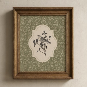 May include: A framed print featuring a detailed illustration of a bird perched on a flowering branch. The artwork is set against a patterned green background and framed in a brown wooden frame. The bird illustration is in black and white.
